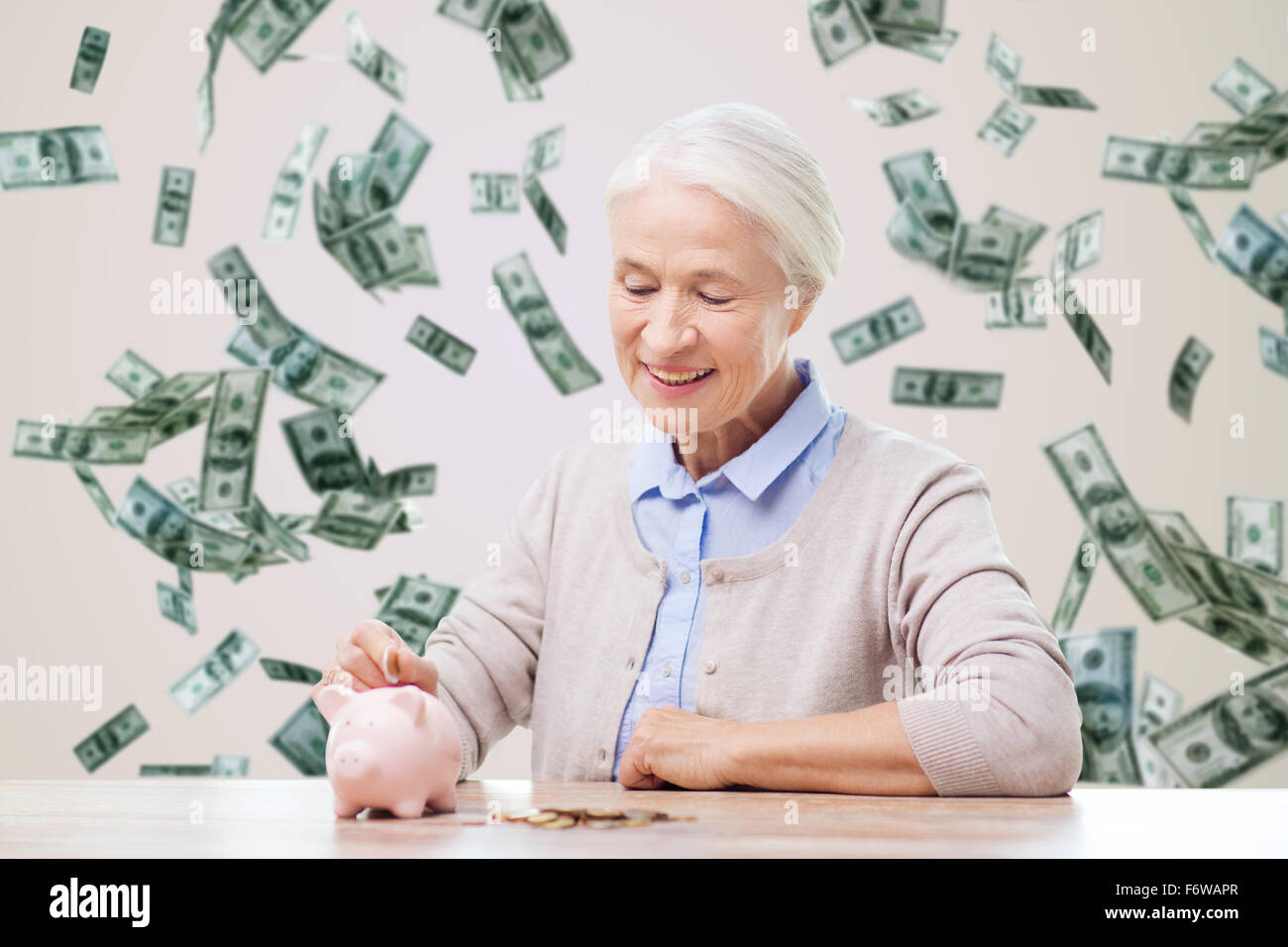 senior woman putting money to piggy bank at home Stock Photo - Alamy