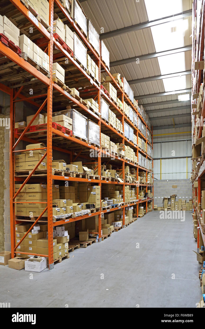 a modern storage warehouse with goods stacked on pallets on high racking Stock Photo