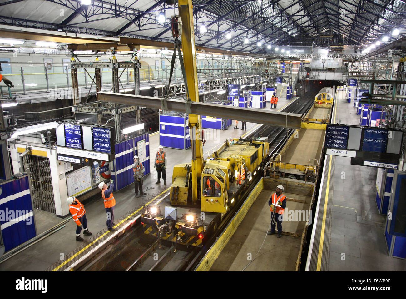 Overnight construction and renovation on London's Underground rail network. Temporary beams are erected at Earls Court Station. Stock Photo