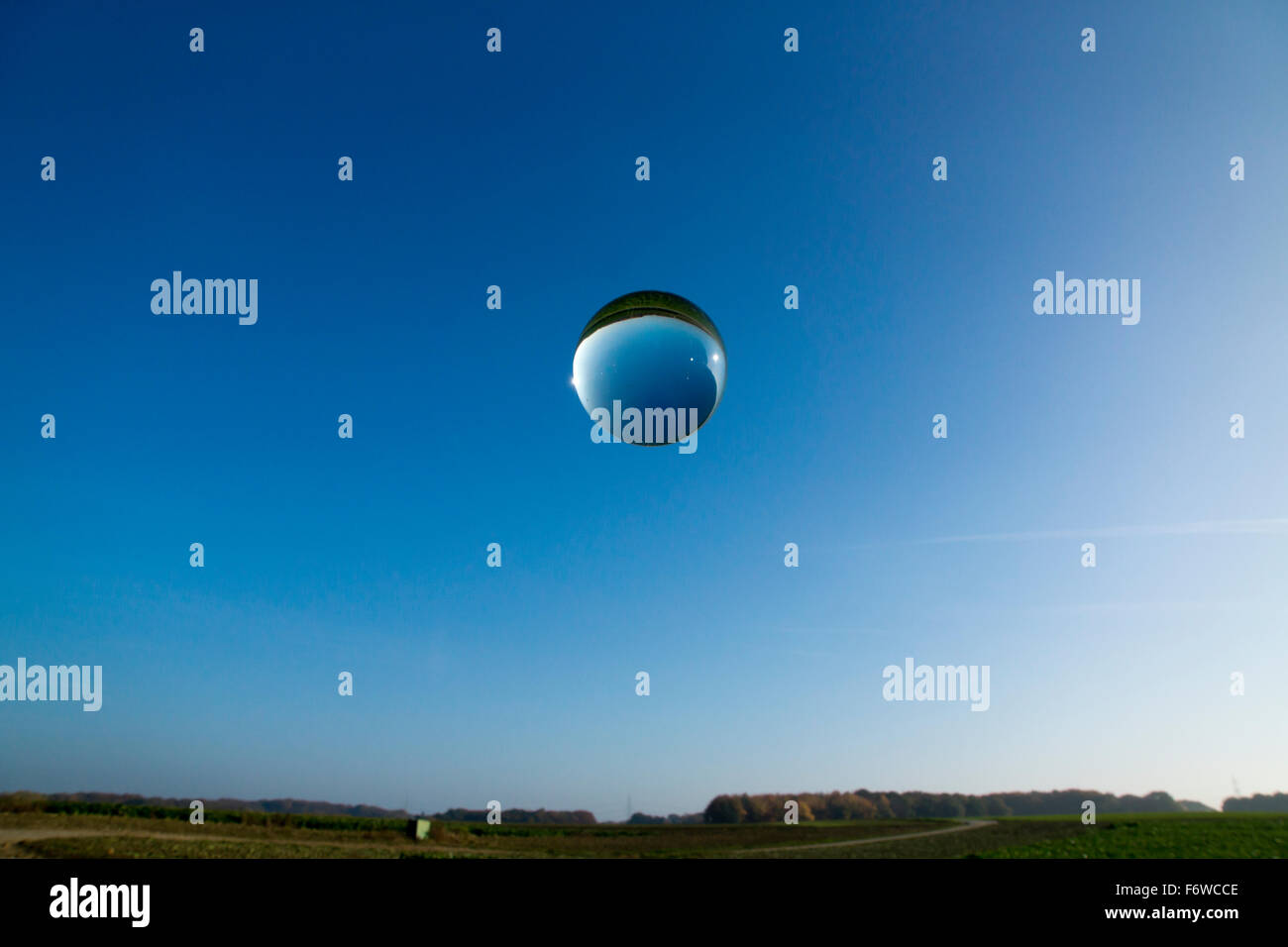 single crystal ball and bubbles in front of blue sky Stock Photo - Alamy