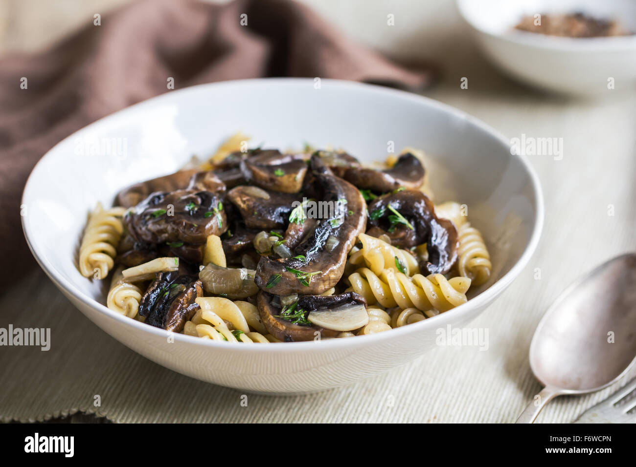 Fusilli with mushroom and herb sauce in a bowl Stock Photo