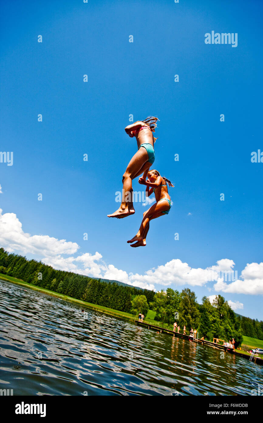 Children jumping into Furtnerteich, Mariahof, Murtal, Styria, Austria Stock Photo
