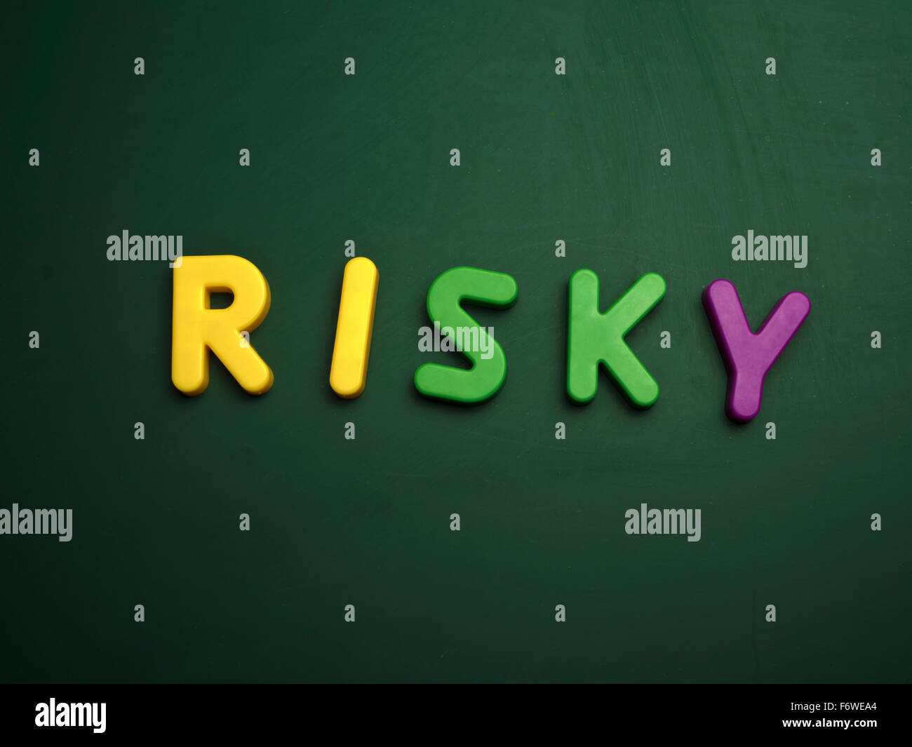 risky concept in colorful letters isolated on blank blackboard Stock Photo