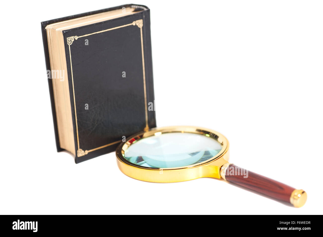 book with magnifying glass over white background Stock Photo - Alamy