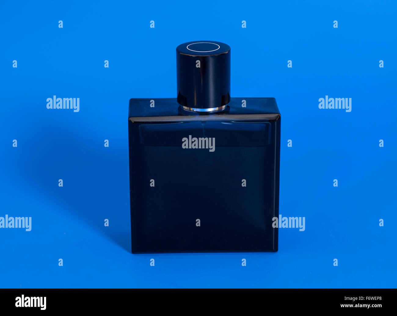 men's perfume in bottle on blue background Stock Photo