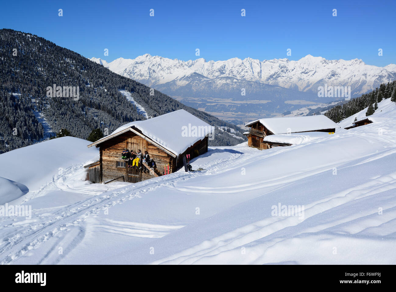 Group of people back-country skiing having a break at snow-covered alpine hut, back-country skiing, Hoher Kopf, Tux Alps, Tyrol, Stock Photo