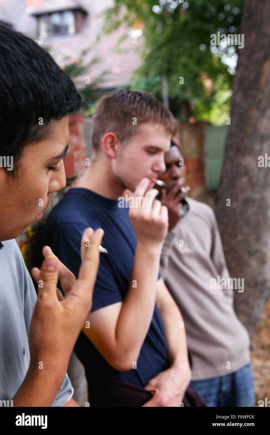 Youths standing around and smoking outside, Stock Photo