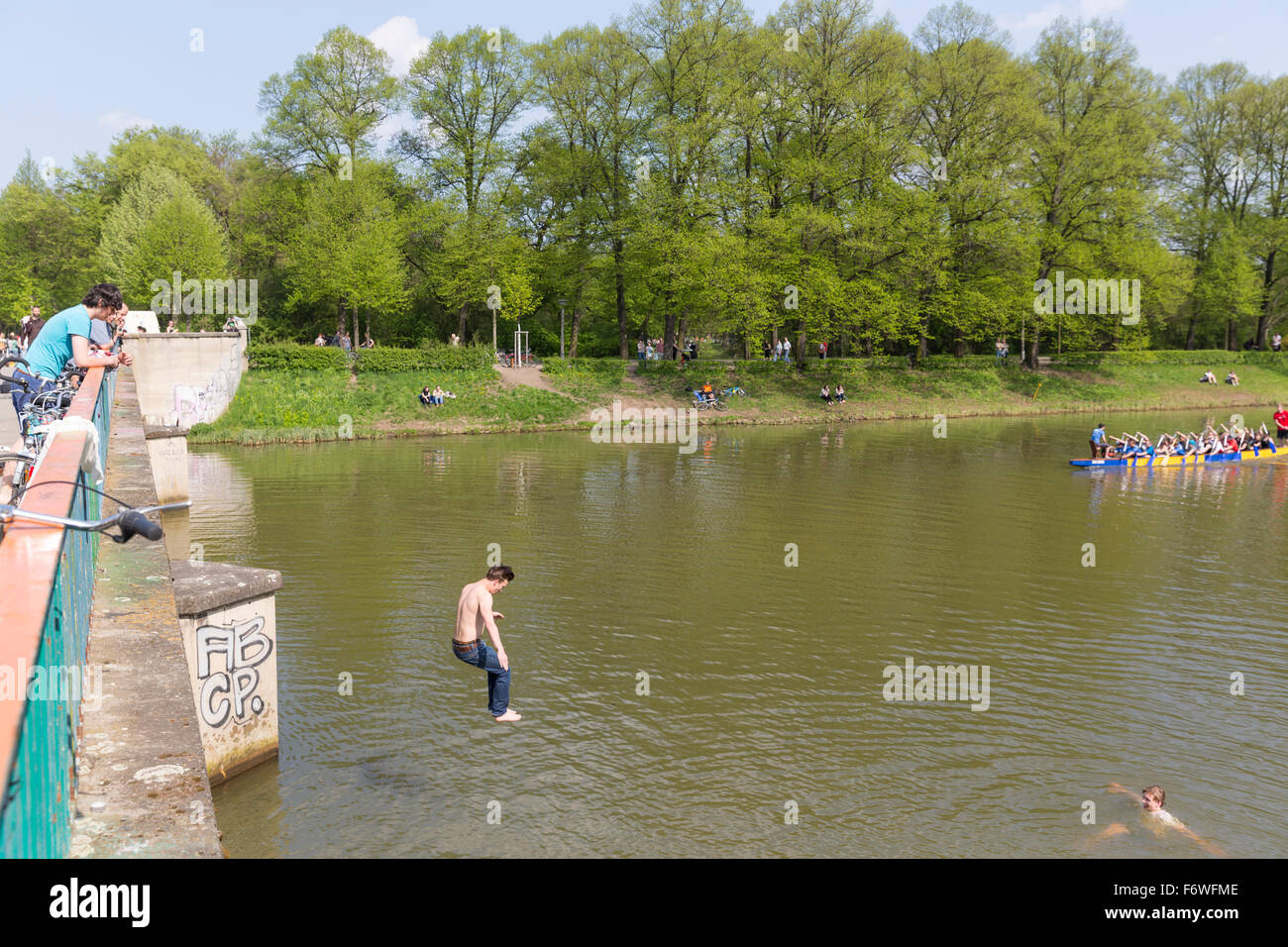 Man jumping from Saxony bridge into water, Clara Zetkin park, Leipzig, Saxony, Germany Stock Photo