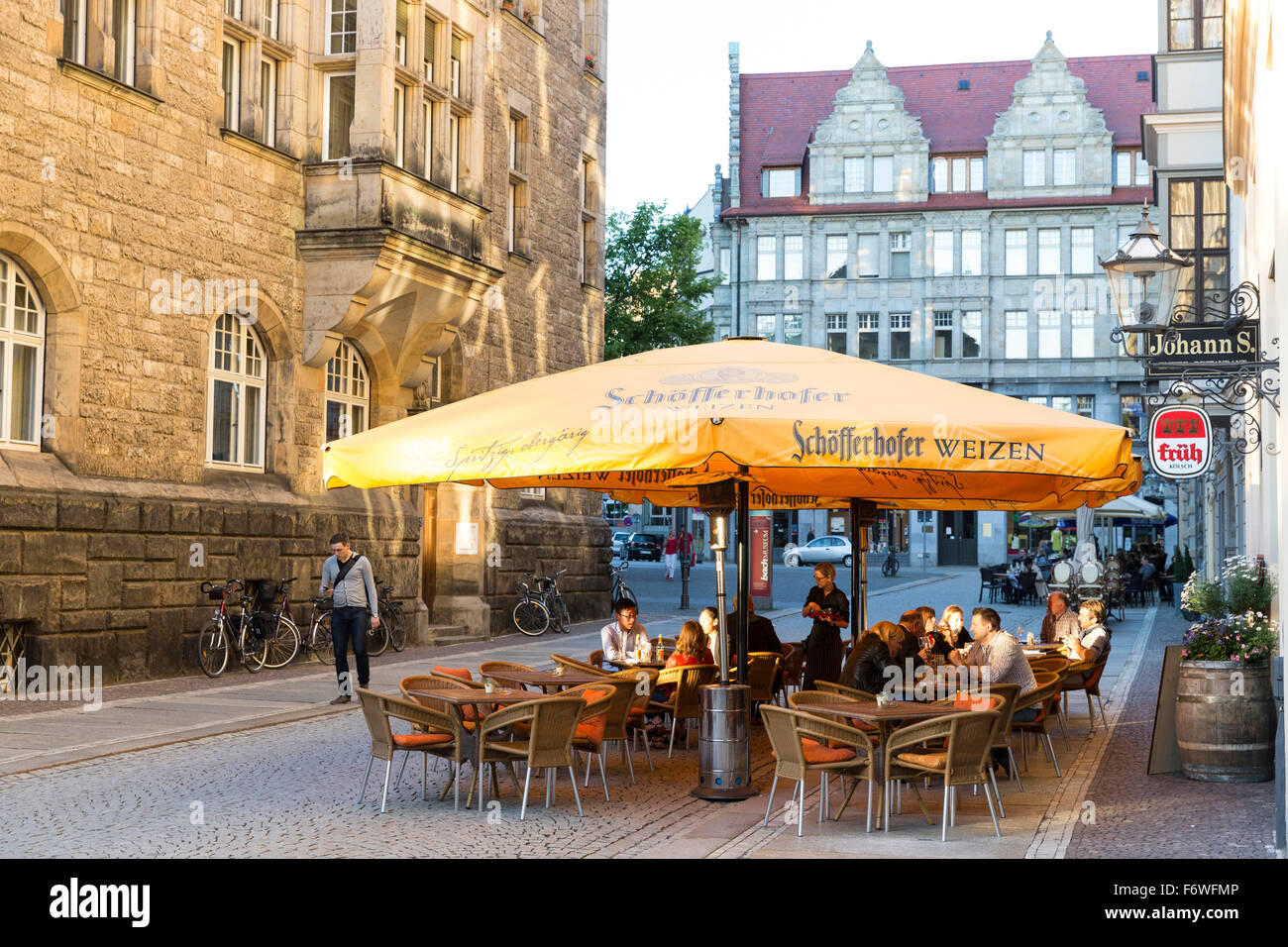 Guests in a pavement restaurant in the evening, Leipzig, Saxony, Germany Stock Photo
