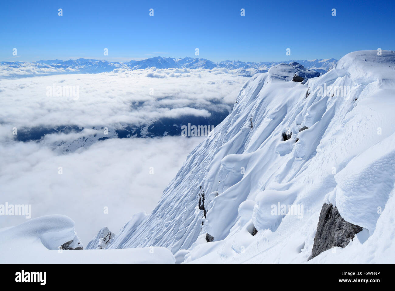 Snow covered south face of Birnhorn with sea of fog in the valleys, back-country skiing, Birnhorn, Leoganger Steinberge range, S Stock Photo