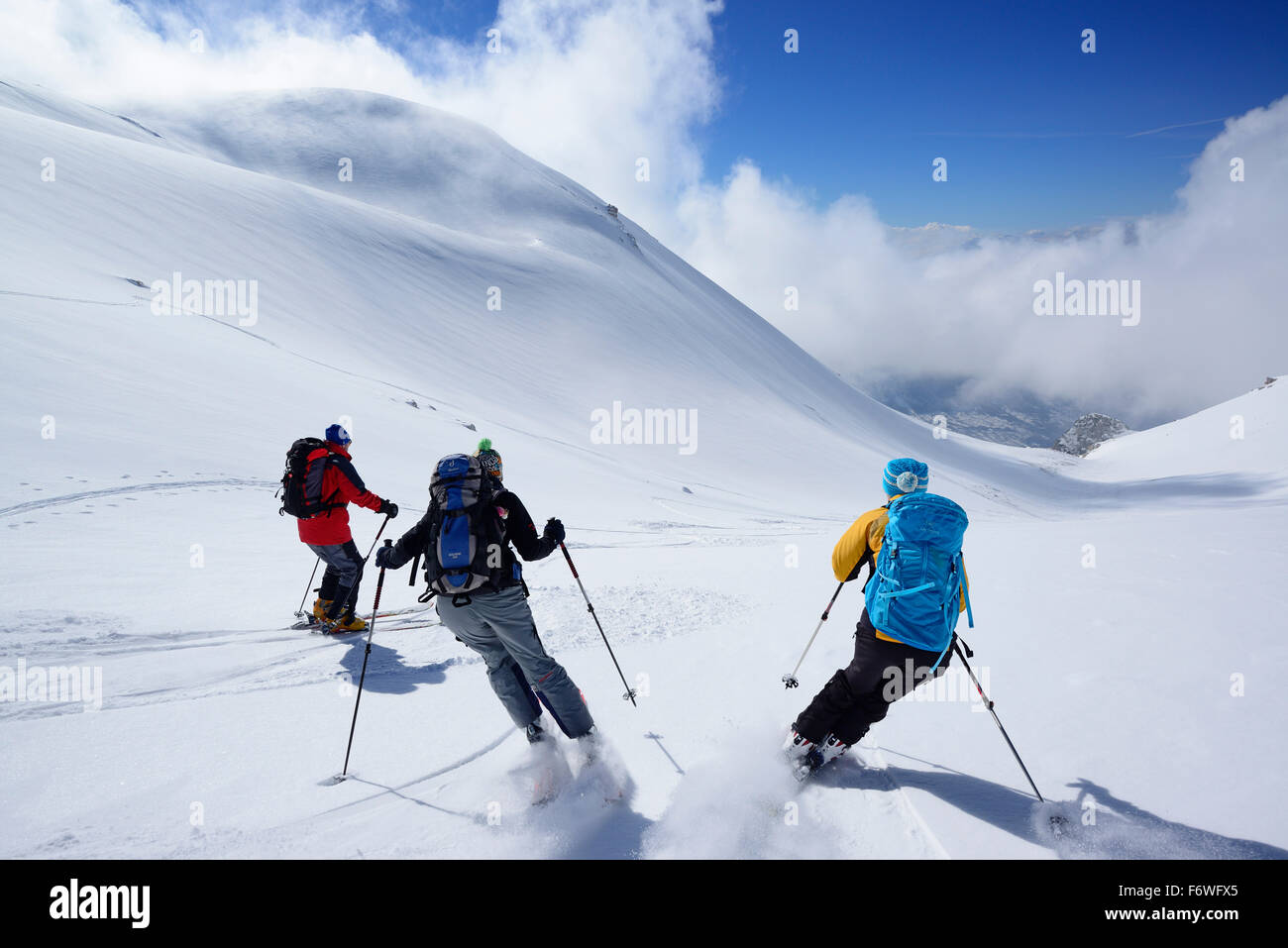 Three backcountry skiers downhill skiing from Monte Pesco Falcone, Rava del Ferro, Maiella, Abruzzo, Italy Stock Photo