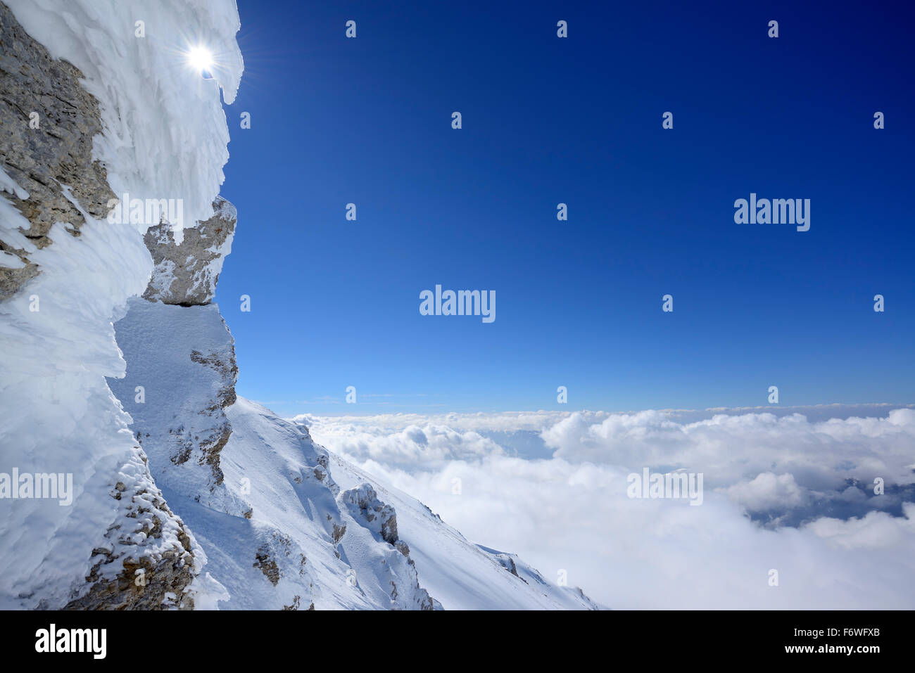 Snow-covered rock with sea of fog in the valley, Rava della Vespa, Monte Amaro, Majella, Abruzzi, Apennines, l' Aquila, Italy Stock Photo