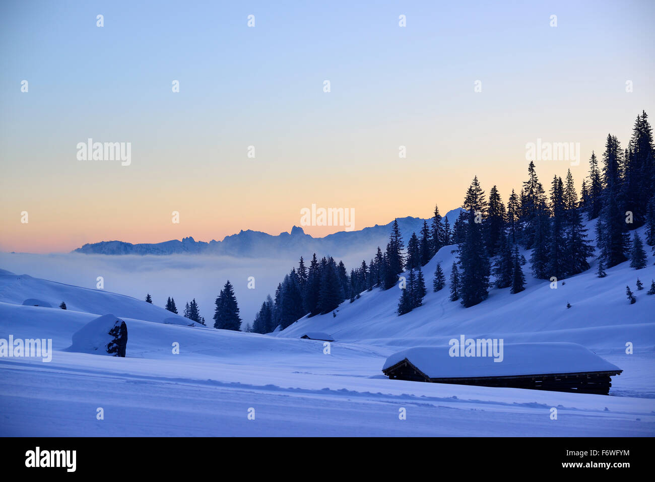 Snow-covered alpine huts with view to Dachstein range, Arthurhaus, Hochkoenig, Berchtesgaden range, Salzburg, Austria Stock Photo