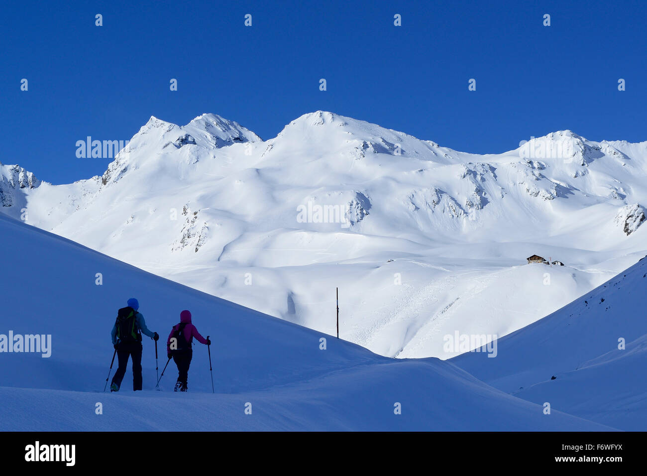 Two female backcountry skiers ascending to Pforzheim Hut, Sellrain, Stubai Alps, Tyrol, Austria Stock Photo