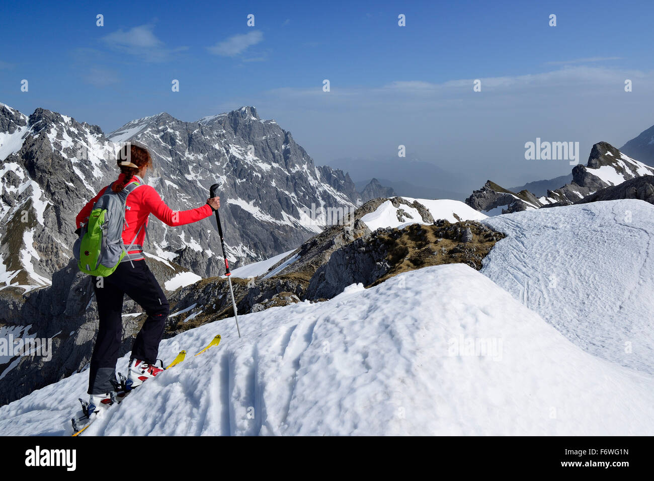 Female backcountry skier looking at Hochkalter, Kematenschneid, Berchtesgaden Alps, Berchtesgaden National Park, Upper Bavaria, Stock Photo