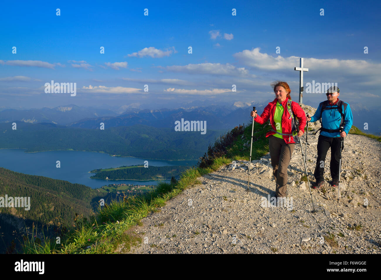 Hikers descending from Heimgarten, lake Walchensee in background, Upper Bavaria, Bavaria, Germany Stock Photo