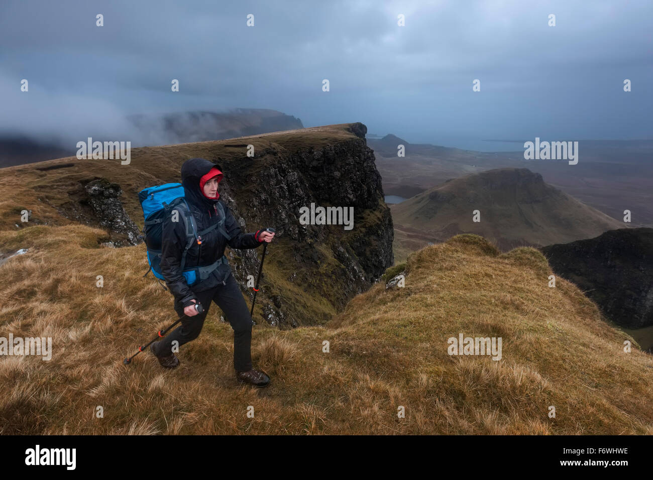 Young woman hiking in rain, Quiraing, Trotternish peninsula, Isle of Skye, Scotland, United Kingdom Stock Photo