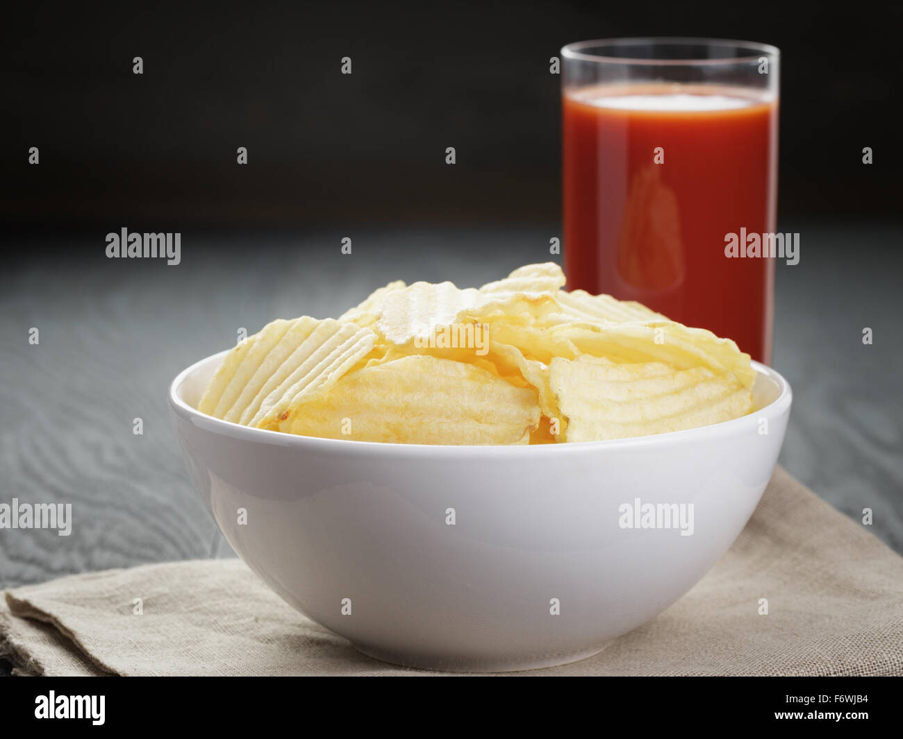 rippled organic chips in white bowl wit tomato juice Stock Photo Alamy