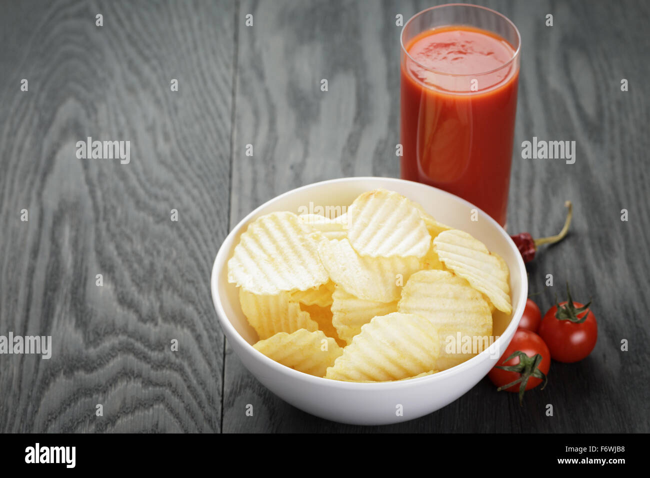rippled organic chips in white bowl wit tomato juice Stock Photo Alamy