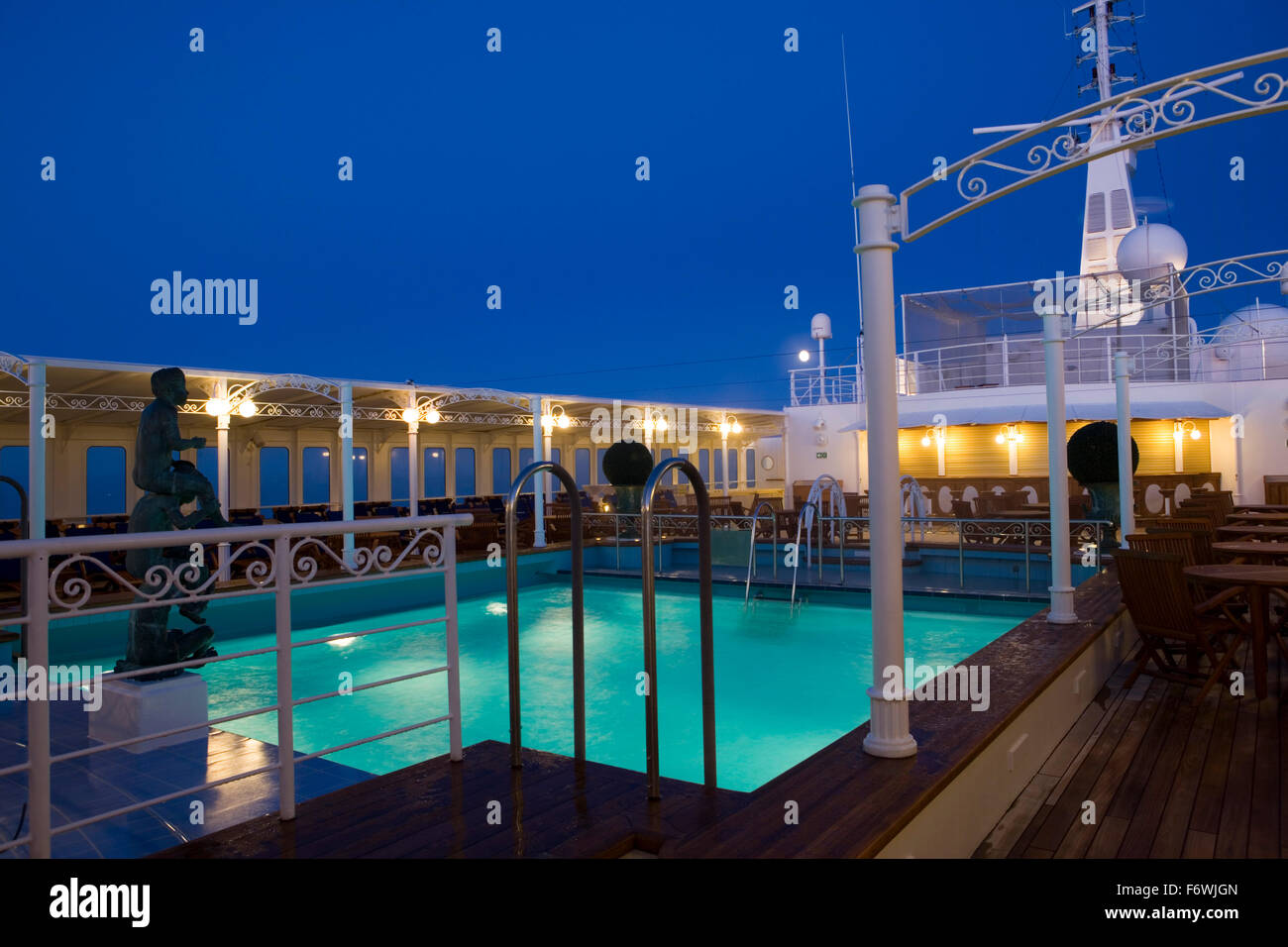 Swimming pool and cruise ship MS Deutschland  Reederei Peter Deilmann  at dusk, Atlantic Ocean, near Greenland Stock Photo