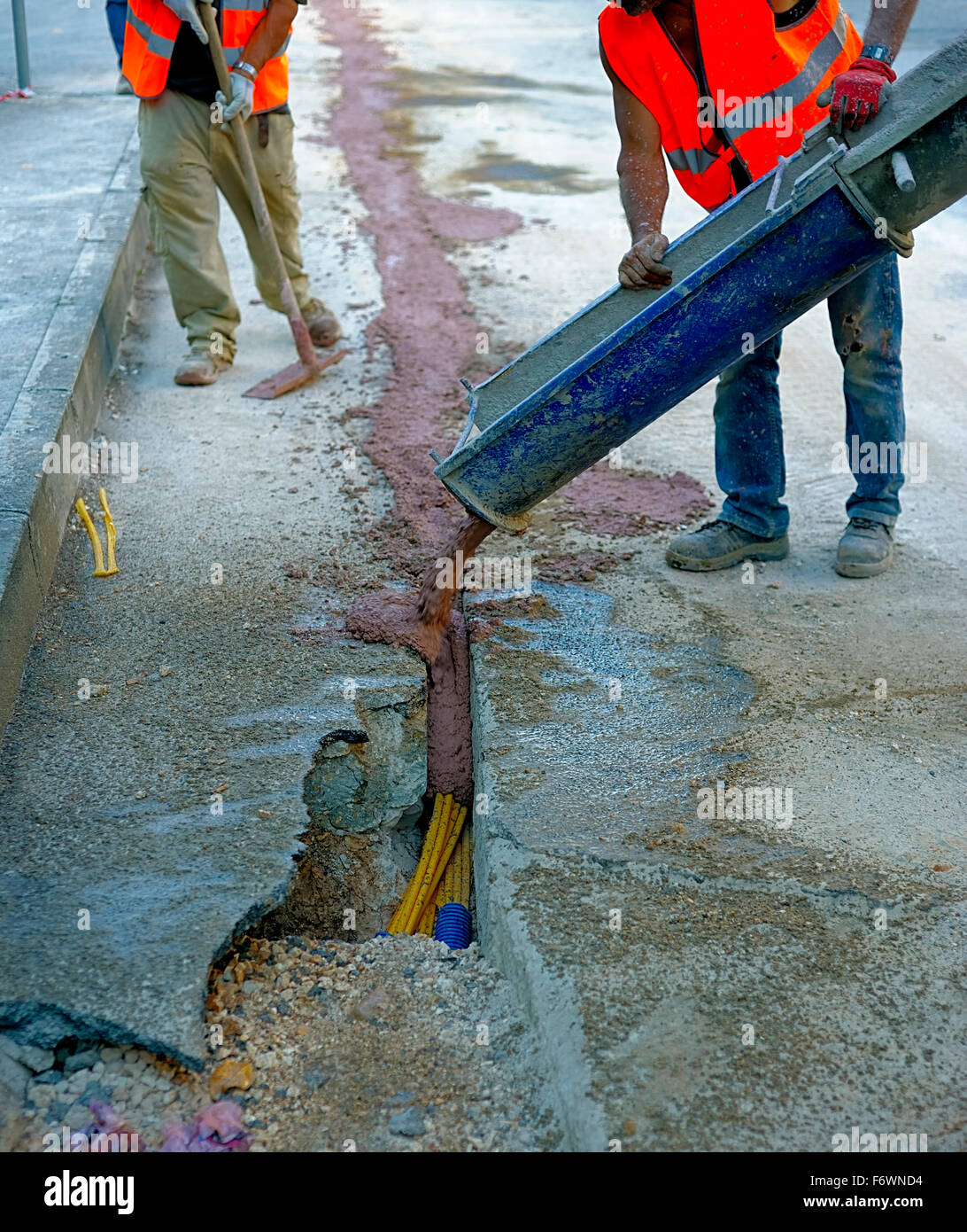 fiber optic cables buried in a micro trench with concrete colored red