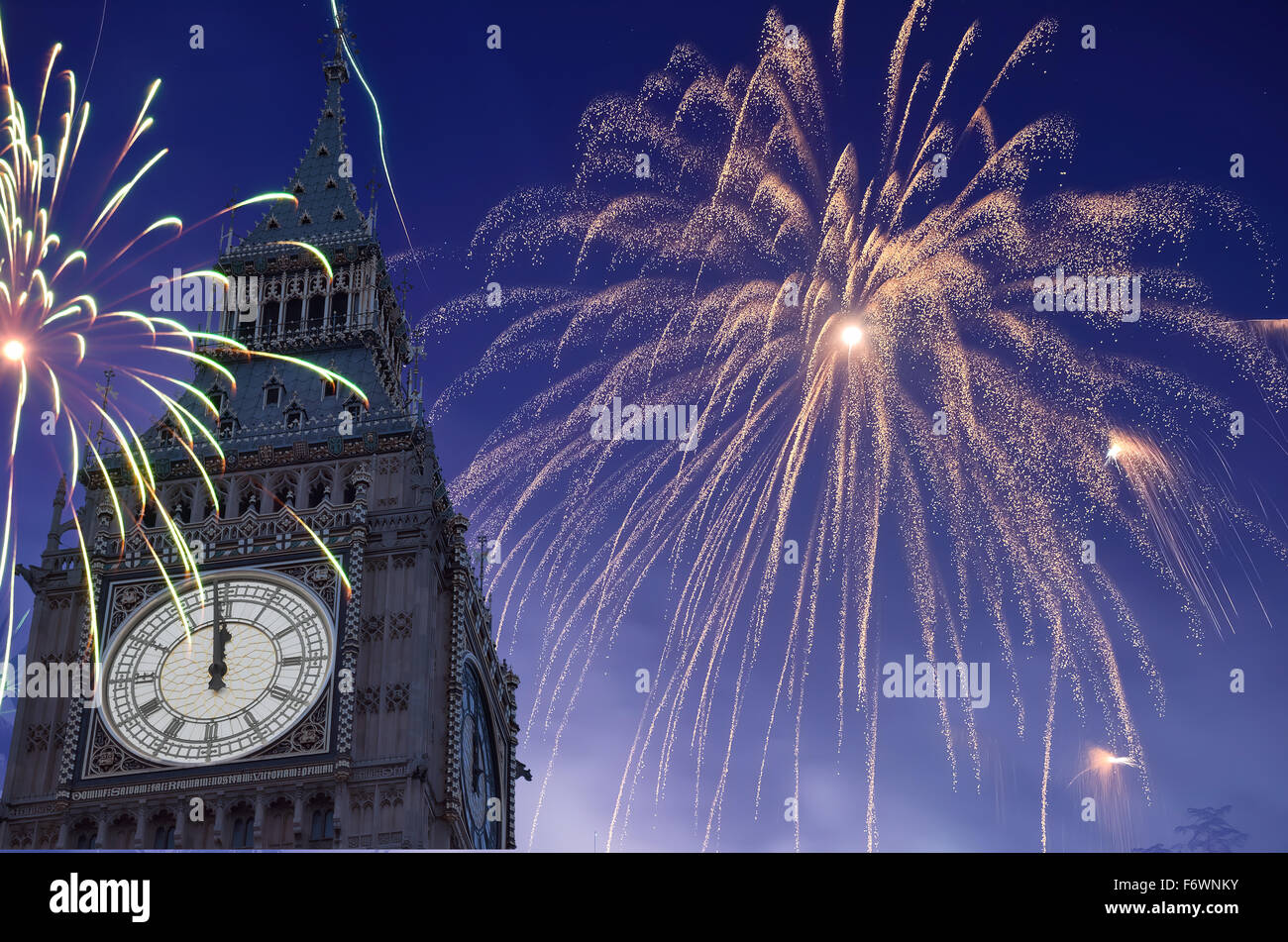12 O'Clock in Big Ben, Fireworks are displayed on sky to celebrate new year. Stock Photo