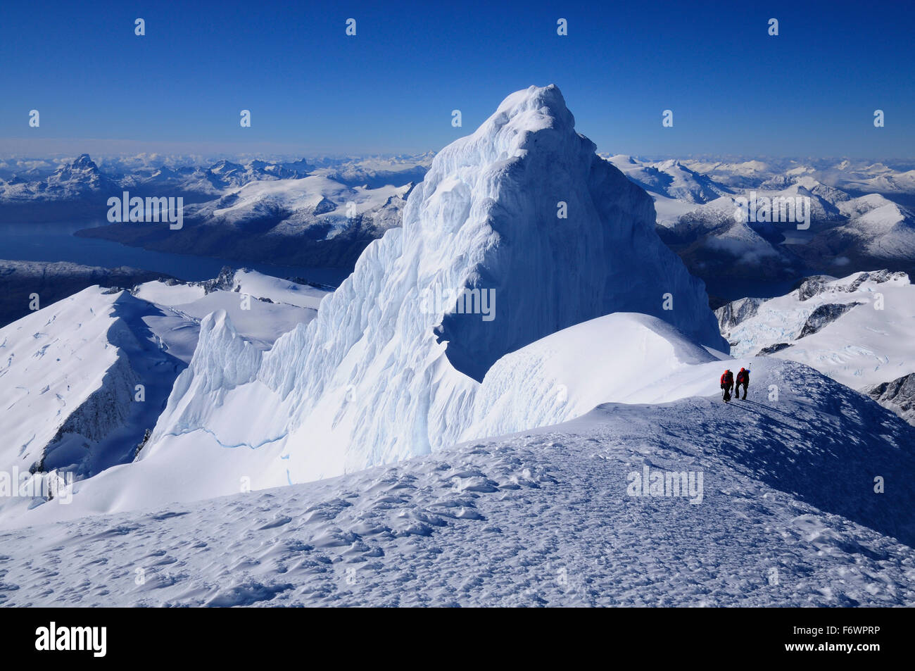 Two mountaineers below the west summit of Monte Sarmiento, Cordillera Darwin, Tierra del Fuego, Chile Stock Photo