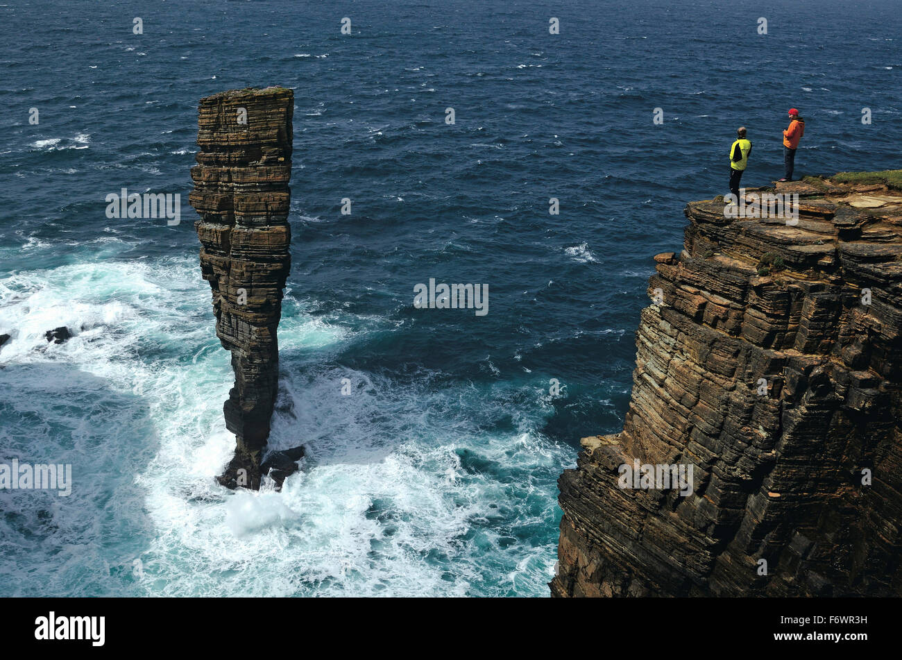 Hikers looking at North Gaulton Castle, West Mainland, Orkney Islands, Scotland, Great Britain Stock Photo