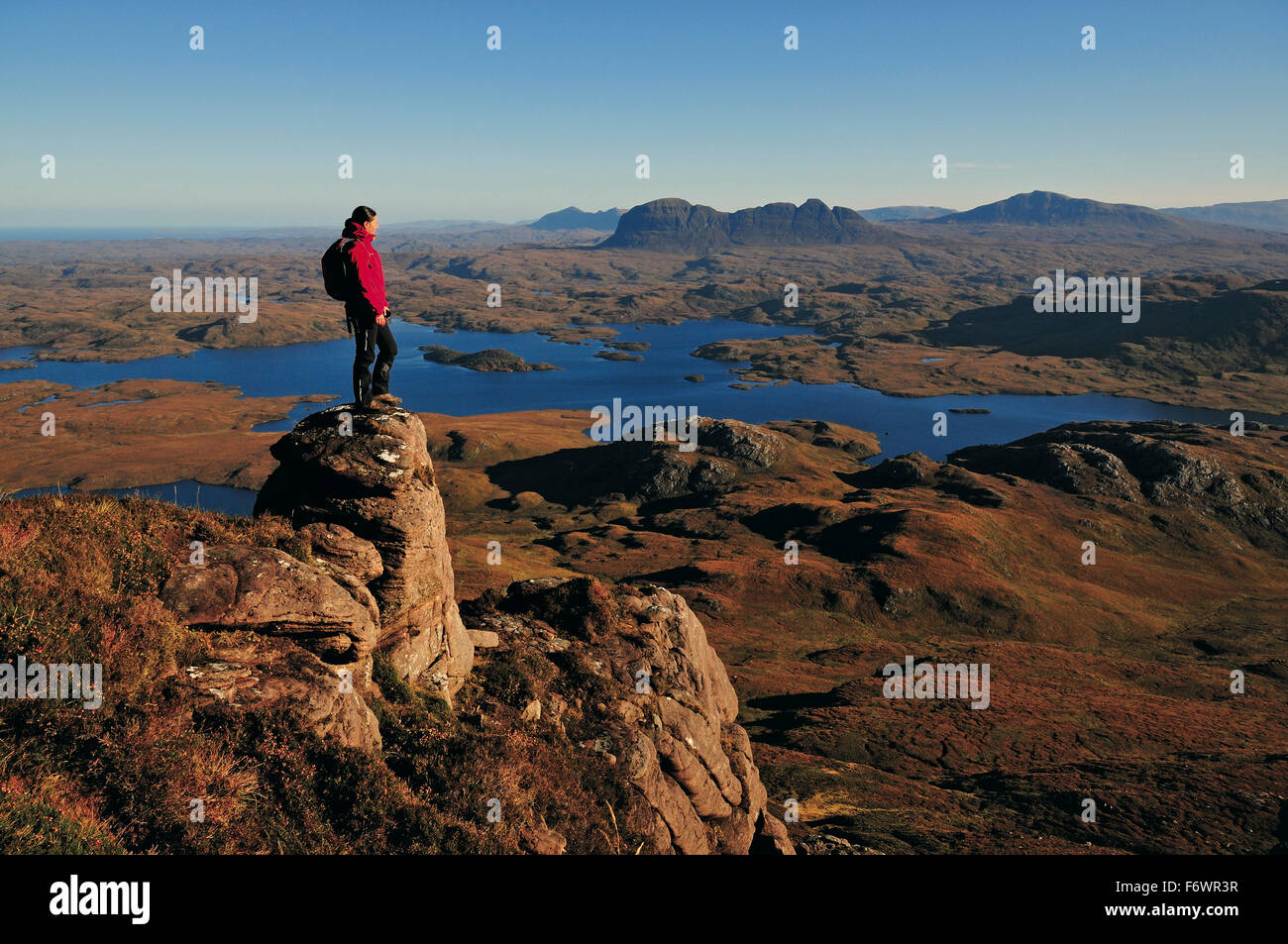 Female hiker at Stac Pollaidh, Suilven in background, Inverpolly Nature Reserve, Highlands, Scotland, Great Britain Stock Photo