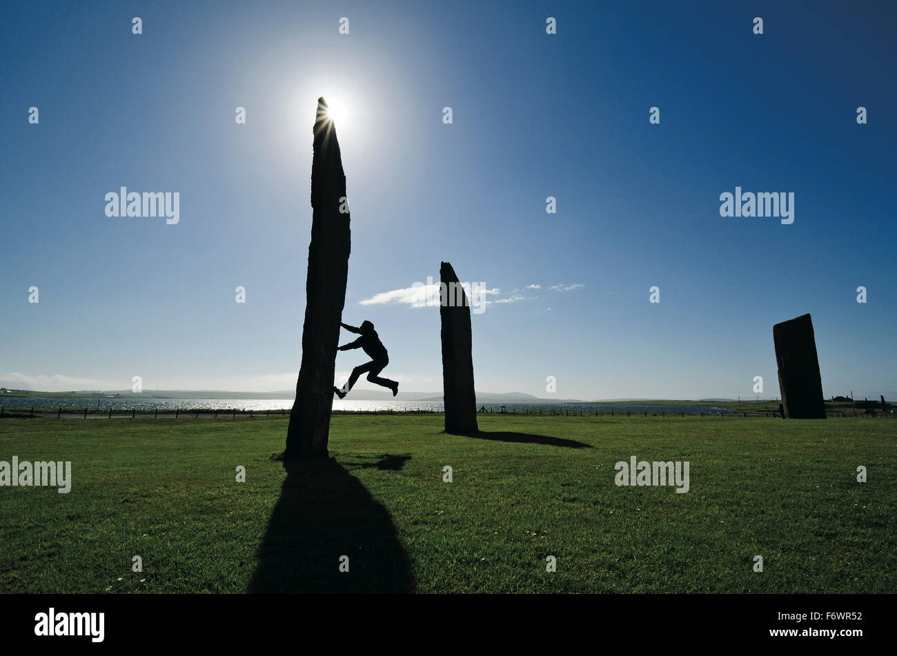 Man climbing at a rock, Standing Stones of Stenness, Mainland, Orkney Islands, Scotland, Great Britain Stock Photo