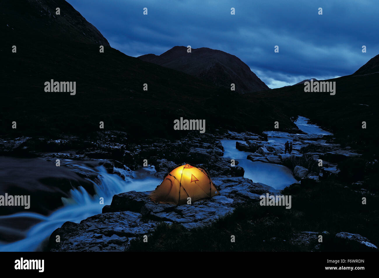 Illuminated tent beside a river, Glen Etive, Highlands, Scotland, Great Britain Stock Photo