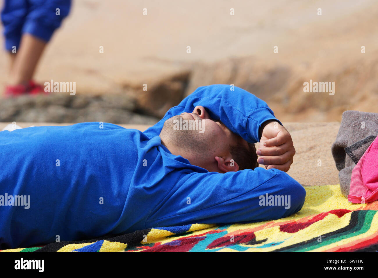 Man relaxing and taking a nap outside in the sun Stock Photo