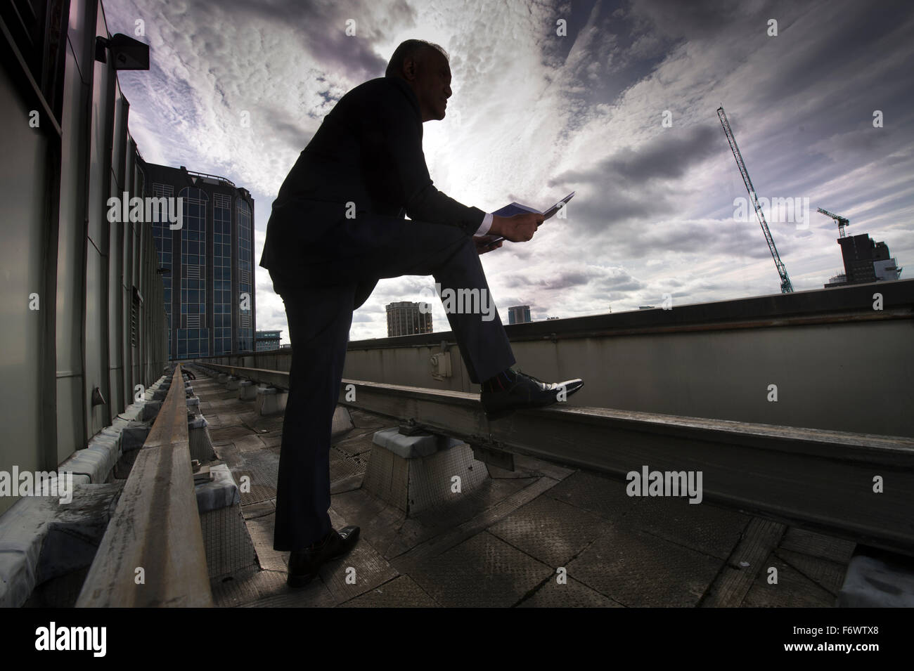 A property businessman looks out over new developments and property renovations in Birmingham UK Stock Photo