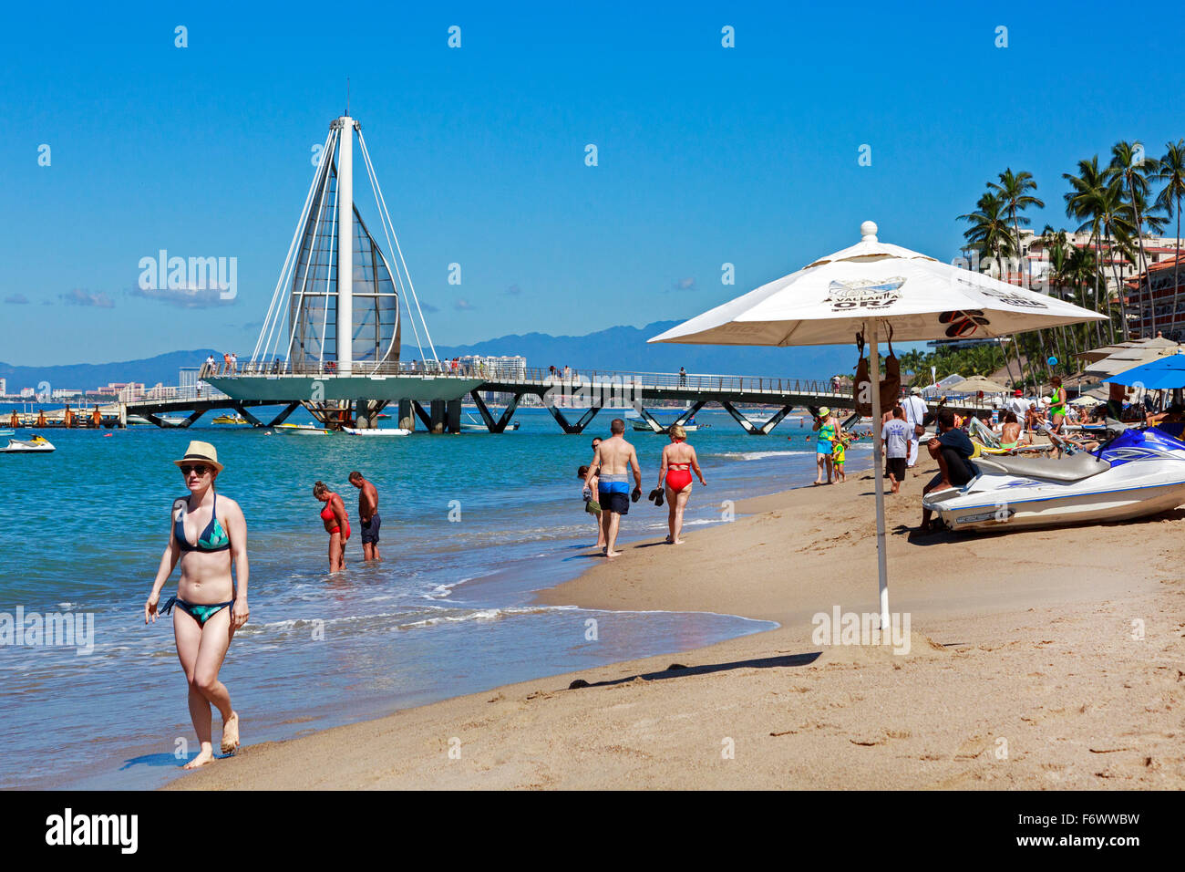 Beach at Zona Romantica, old town of Puerto Vallarta, Mexico with the Los Muertos Pier in the background Stock Photo