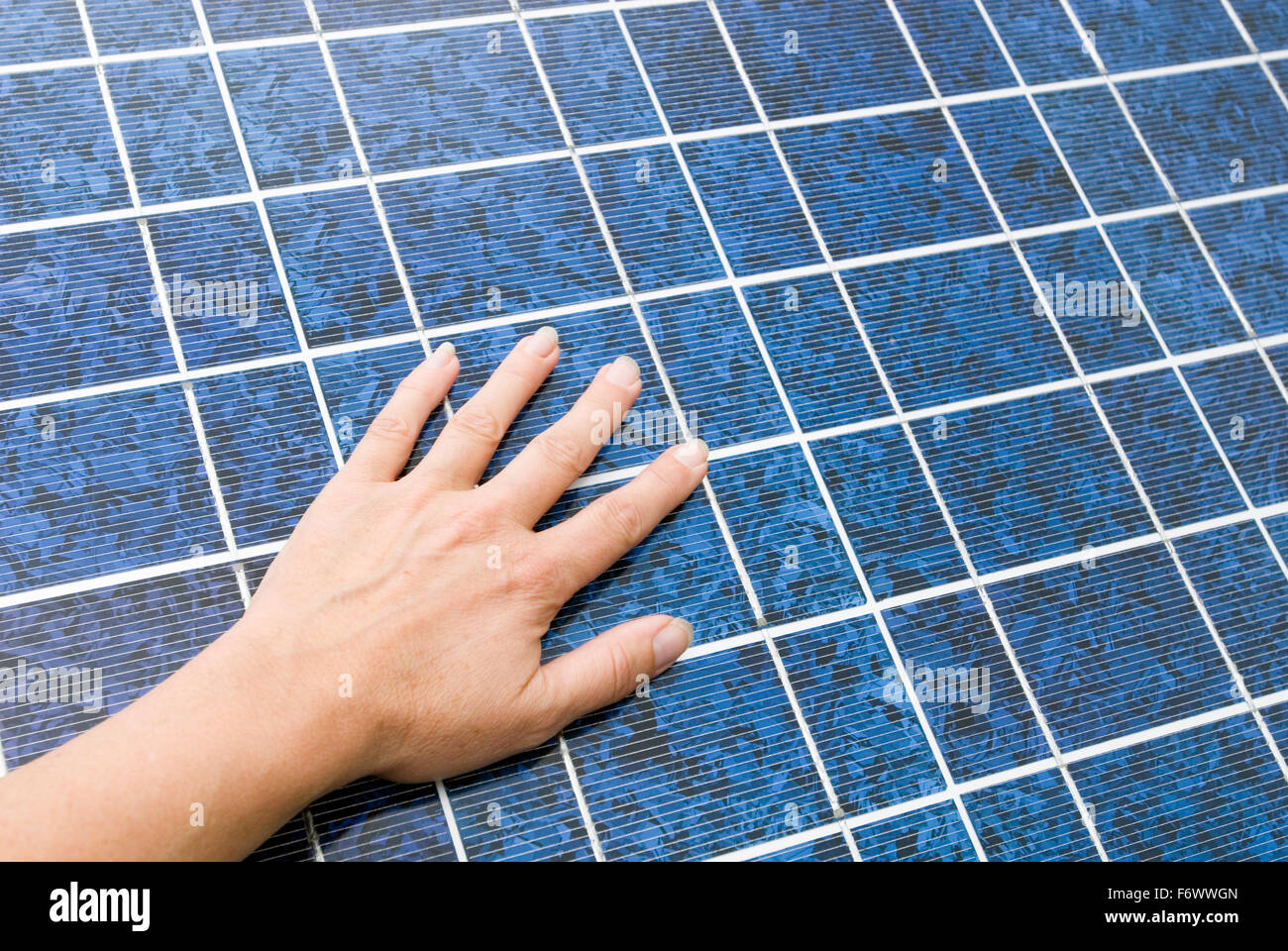 Hand on a solar cell Stock Photo
