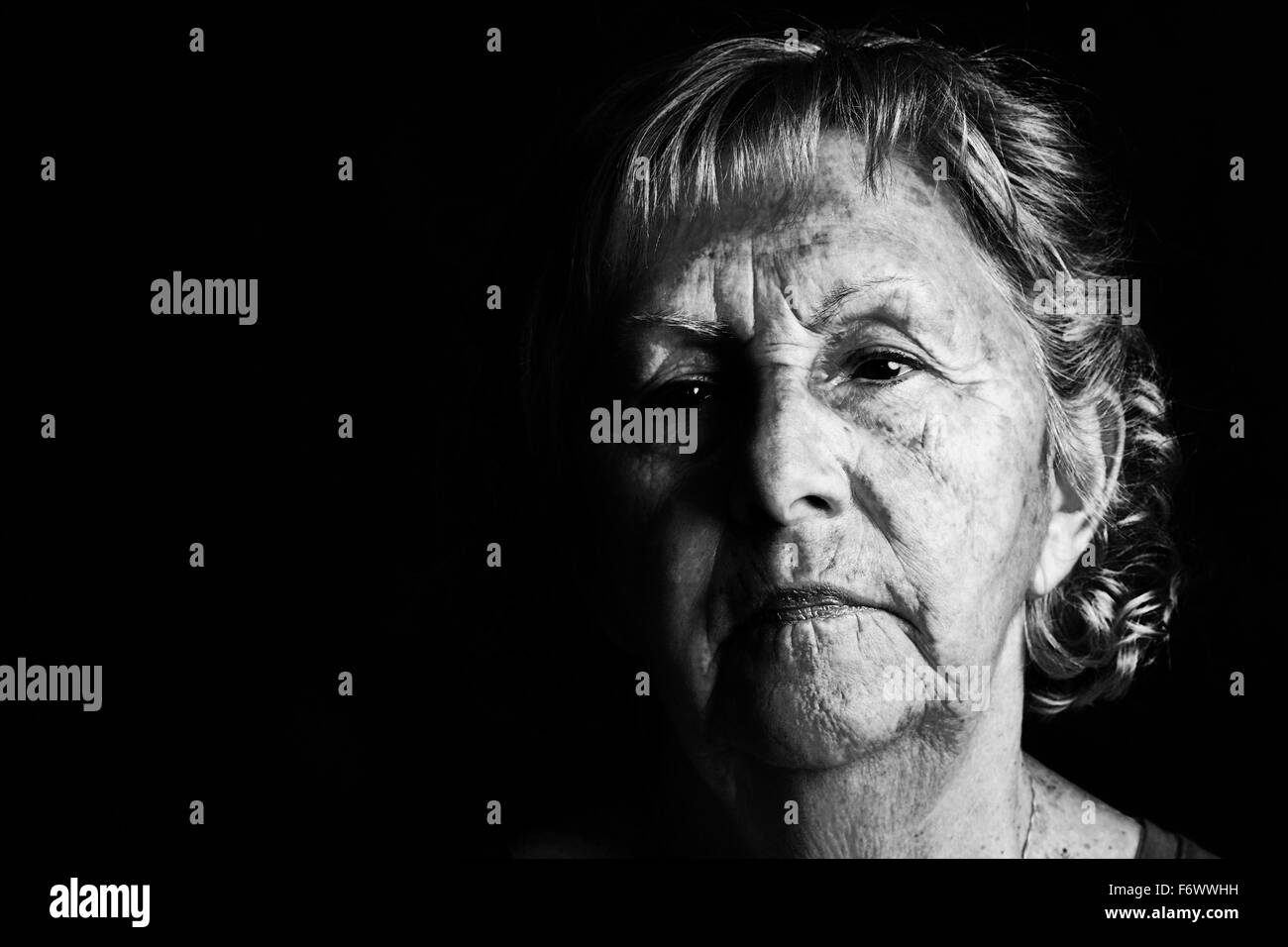 Dramatic black and white portrait of a senior woman looking away Stock Photo
