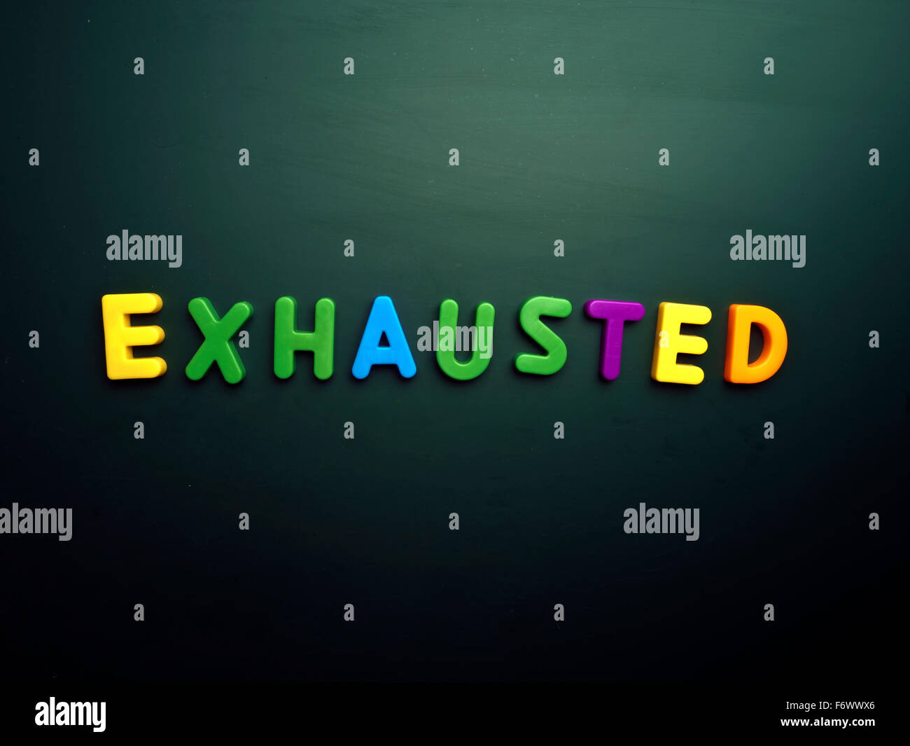 exhausted concept in colorful letters isolated on blank blackboard