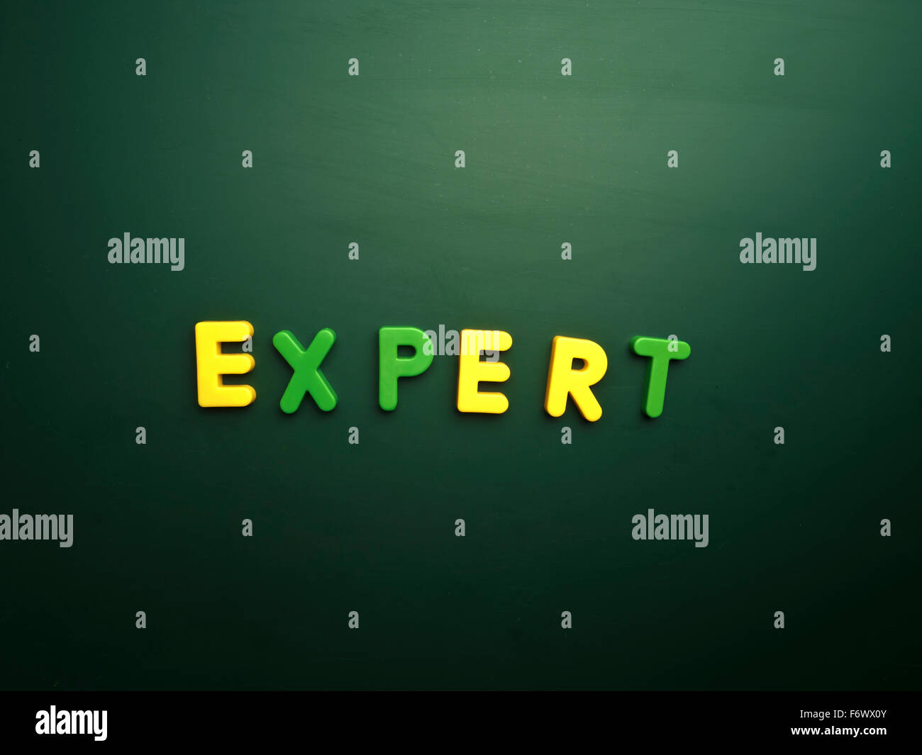 expert concept in colorful letters isolated on blank blackboard Stock Photo