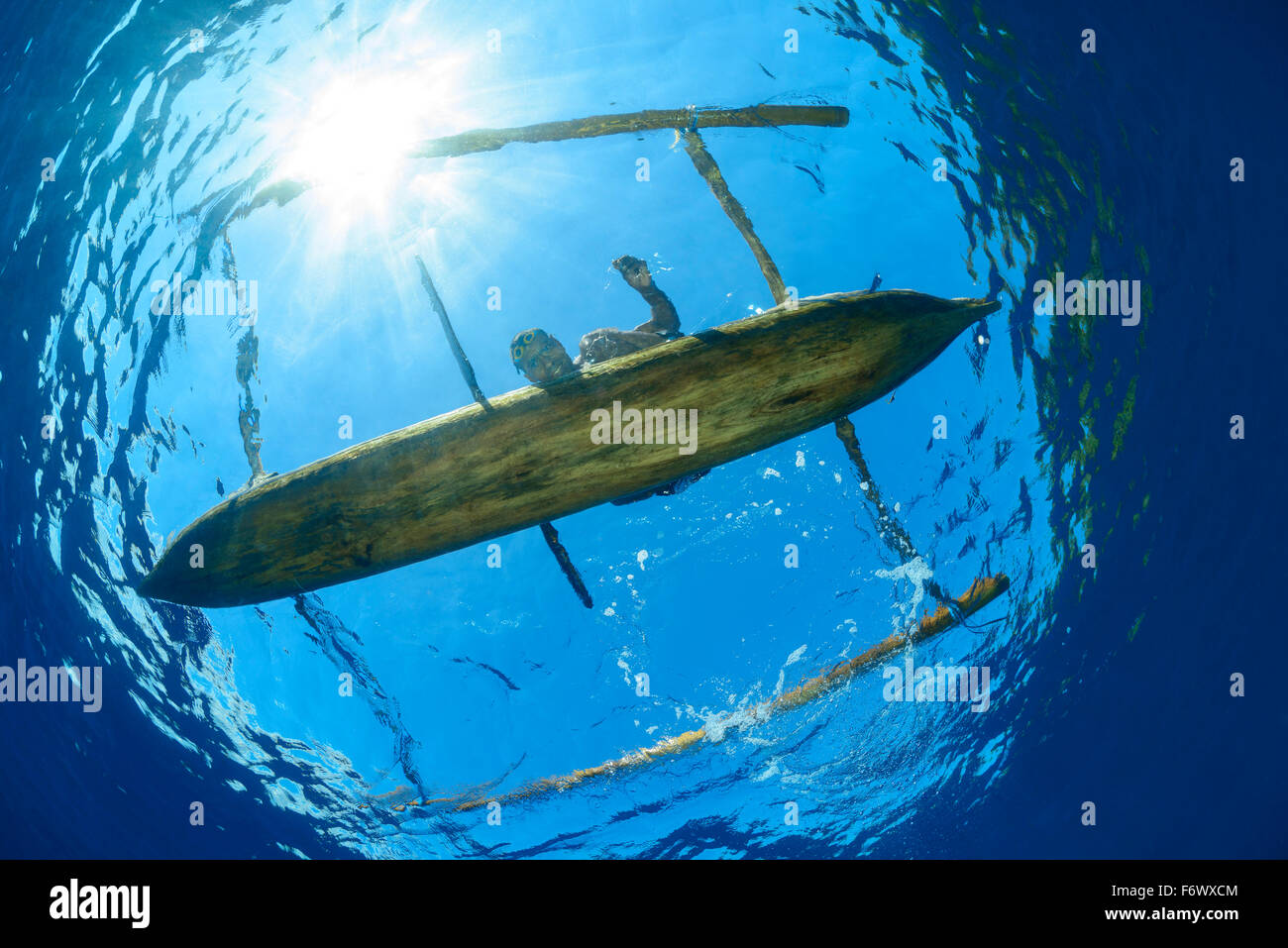 Local Spear Fisherman with outrigger boat, Alor Archipelago, Indonesia, Sawu Sea, Pantarstrait, Indian Ocean Stock Photo