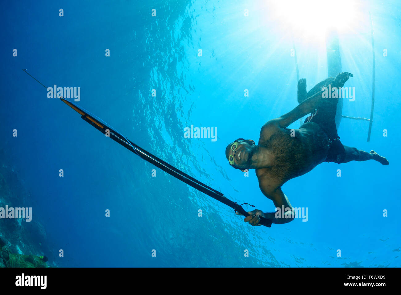 Local Spear Fisherman with outrigger boat, Alor Archipelago, Indonesia, Sawu Sea, Pantarstrait, Indian Ocean Stock Photo