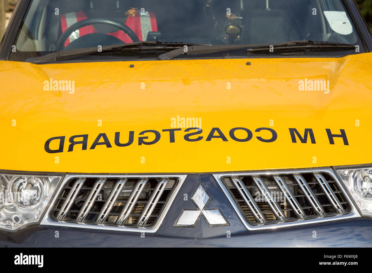 Coastguard sign with mirror writing on hood of vehicle, England, UK Stock Photo