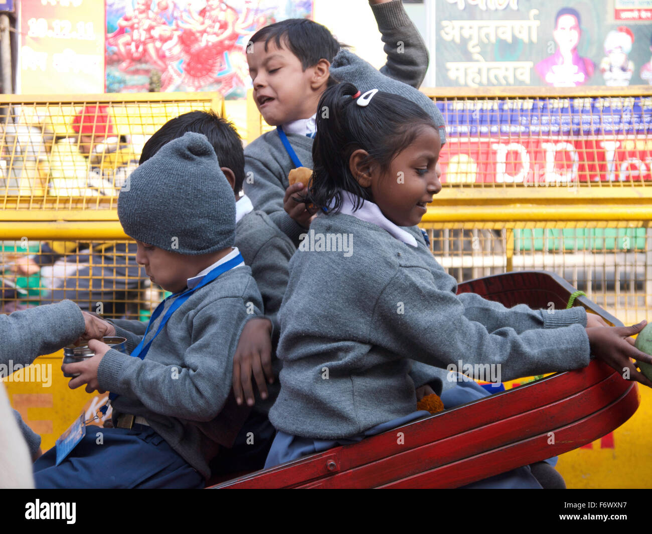 Lift to school - lively schoolchildren make their way to school in cart transport - Delhi India Stock Photo