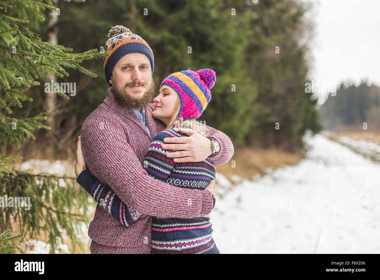 Young couple hugging in winter forest Stock Photo - Alamy