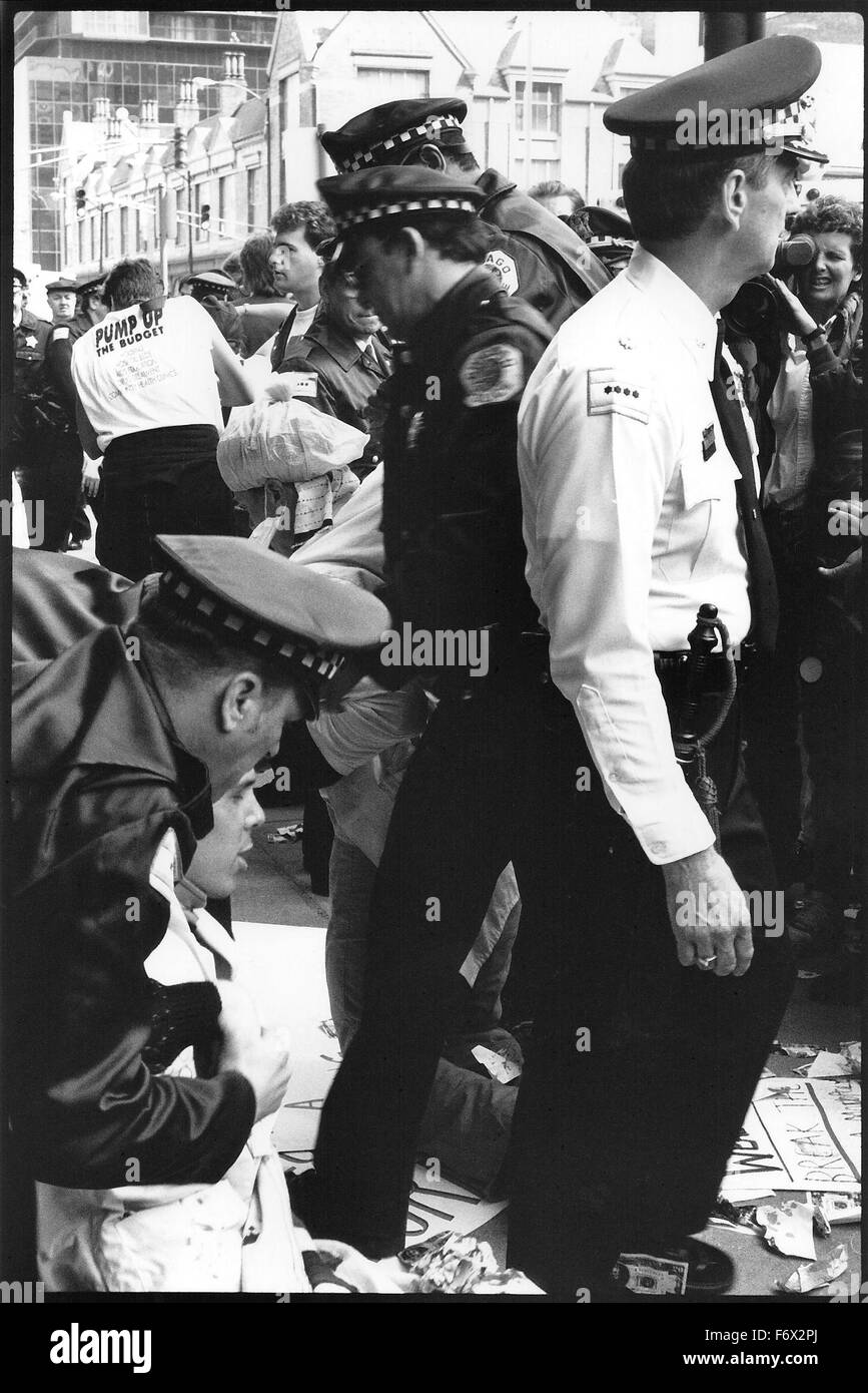 ACT-UP (The AIDS Coalition To Unleash Power) Chicago and several other ACT-UP chapters from around the USA, including ACT-UP New York demonstrated against the AMA (American Medical Association) and the Cook County Hospital on April 23 1990, demanding better AIDS care and funding. Two protestors including political cartoonist Danny Sotomayer, entered Chicago City Hall and hung a banner demanding equal healthcare for AIDS patients. Protestors held die-ins, did street theatre and blocked major streets to set up a 'Women's AIDS Ward' to protest the lack of local hospital beds for Women with AIDS. Stock Photo