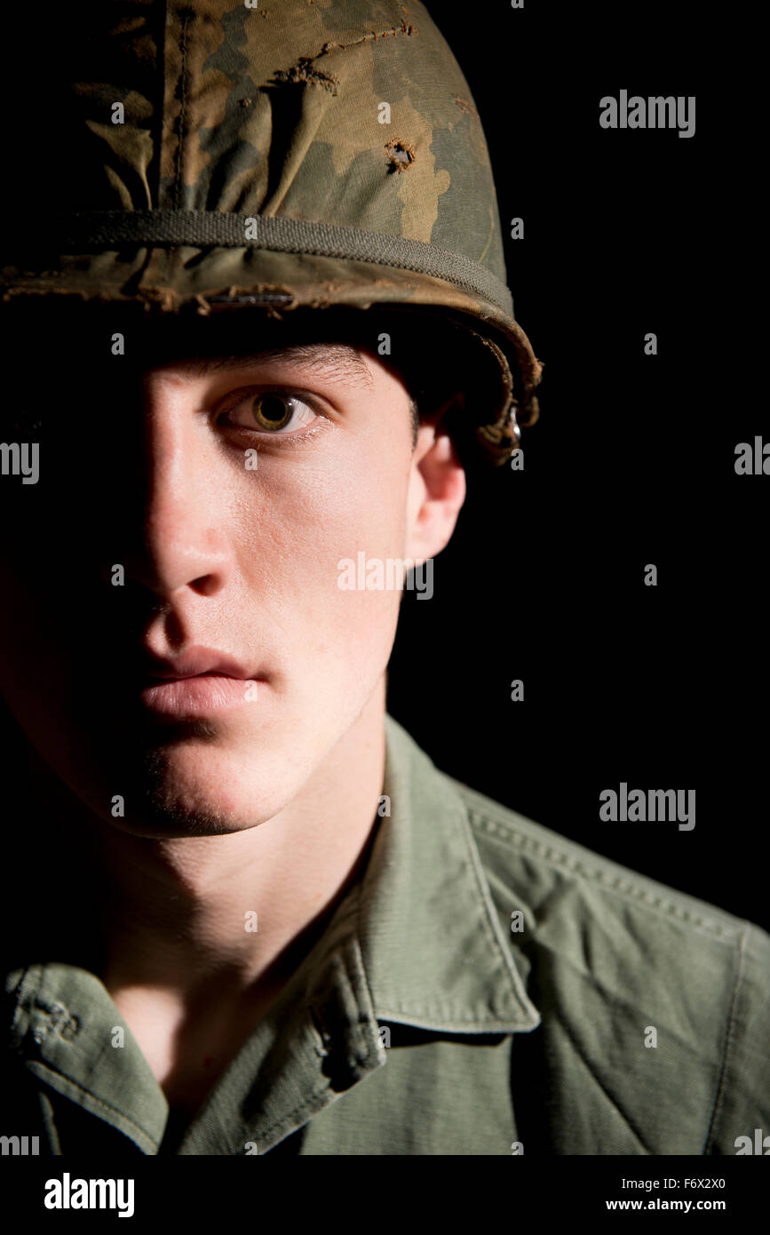 Shell shocked soldier (US Marine / Vietnam War) with face covered in dirt,  against a dark background Stock Photo - Alamy