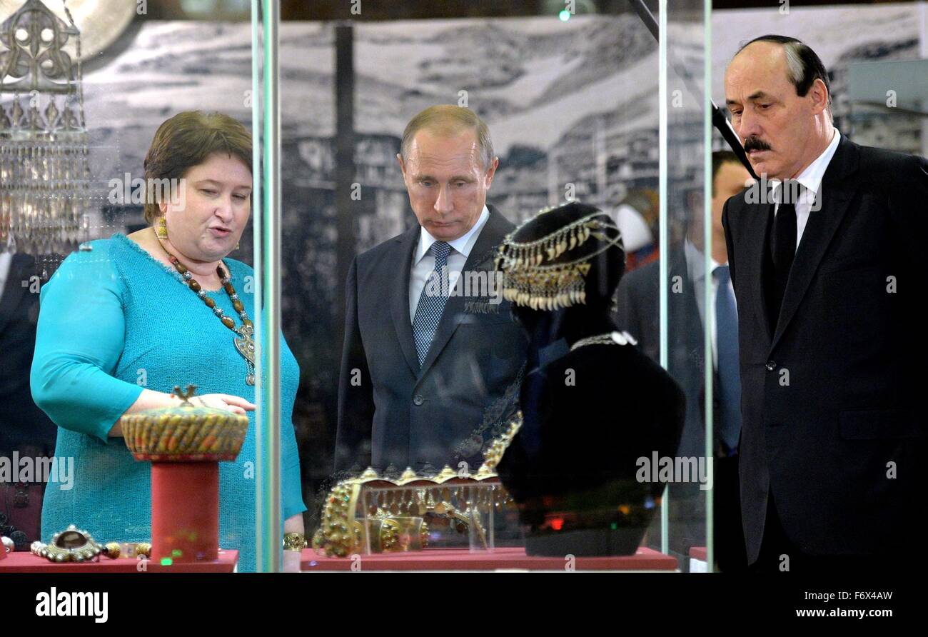 Director of the Dagestan Museum of Fine Arts Salikhat Gamzatova shows Russian President Vladimir Putin and Dagestan President Ramazan Abdulatipov, right, an exhibition on the 2000th anniversary of the city of Derbent in the State Historical Museum November 3, 2015 in Moscow, Russia. Stock Photo