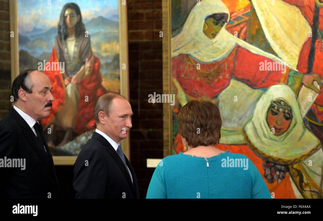 Director of the Dagestan Museum of Fine Arts Salikhat Gamzatova shows Russian President Vladimir Putin and Dagestan President Ramazan Abdulatipov, left, an exhibition on the 2000th anniversary of the city of Derbent in the State Historical Museum November 3, 2015 in Moscow, Russia. Stock Photo