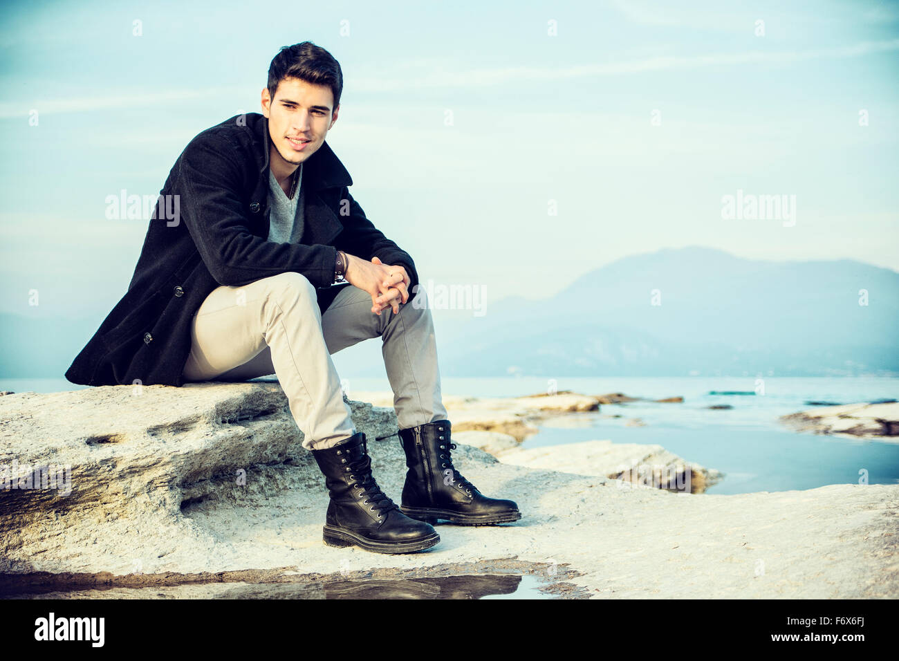 Man sitting on rock shore hi-res stock photography and images - Alamy