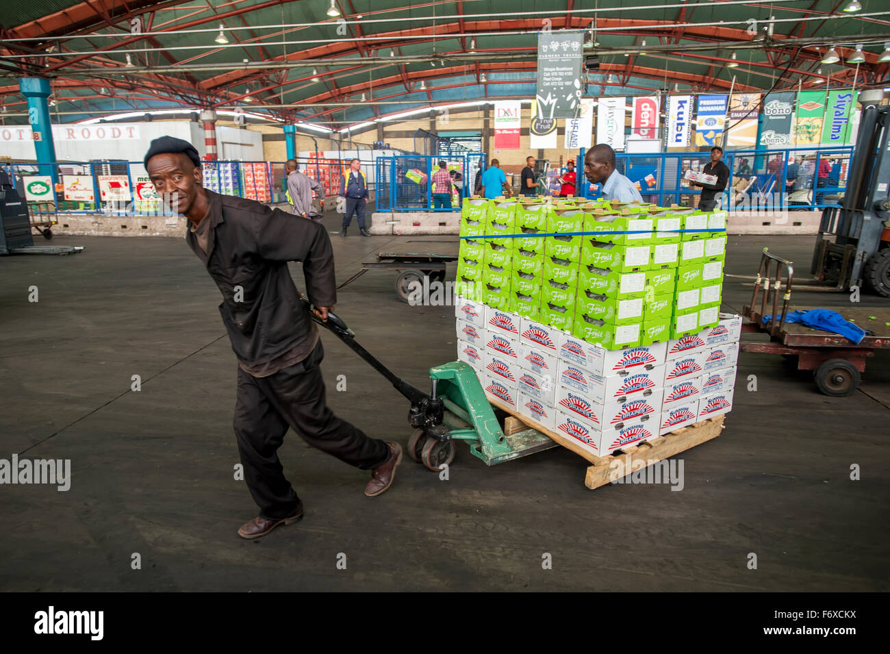 Man pulling a loaded cart at the Tshwane Fresh Produce Market; Pretoria