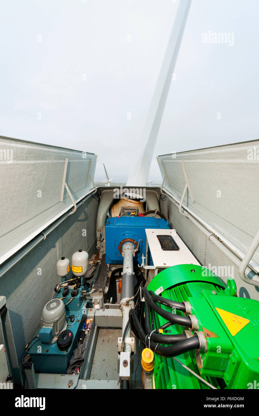 The open side of a wind turbine with the low speed shaft, gear box, and generator visible, St